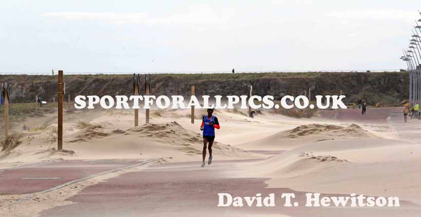 Weynay Ghebresilasie battles through a sand storm on his way to winning the Sand Dancer, South Shields.